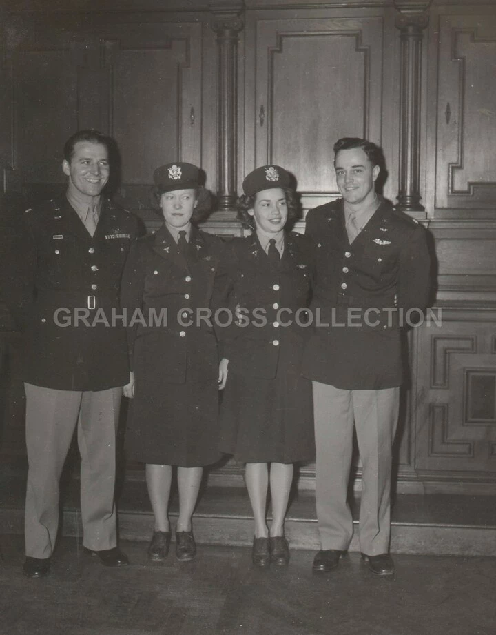 Lt Col. J. Bradley McManus (right) of the 364th Fighter Group met his future wife, Flight Nurse Lt. Lois Bebout (next to MacManus) travelling to the United Kingdom on the Queen Elizabeth. This photo is of their wedding reception at Honington. Left is Lt Col. George F. Ceuleers.