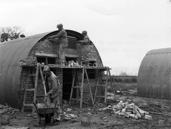 Men from the 829th Engineer (Aviation) Battalion build a Nissen Hut at Eye (US Army Corp of Engineers).