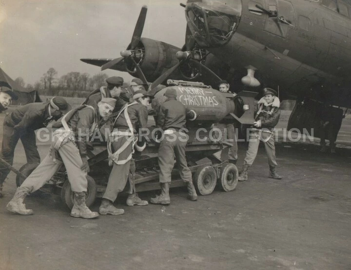 A staged photo of a 385th Bombardment Group crew moving a ‘festive’ payload towards their aircraft.