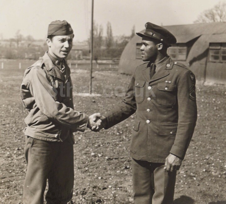 Lt. Col. Houghton R. Hallock congratulates T/Sgt. Hardy on receiving the Legion of Merit Award at Debach May 1, 1944. The award was given to those 'who have distinguished themselves by exceptionally meritorious conduct in the performance of outstanding services.