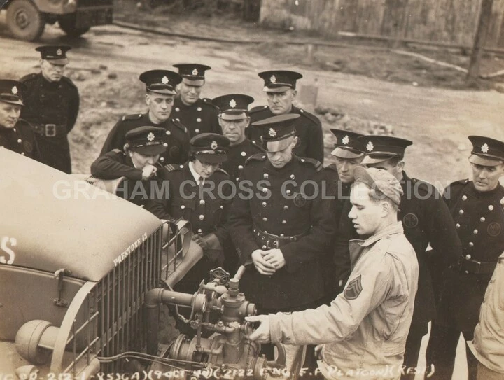 A member of the station fire-fighting platoon demonstrates some equipment to members of the local fire service at Martlesham Heath.
