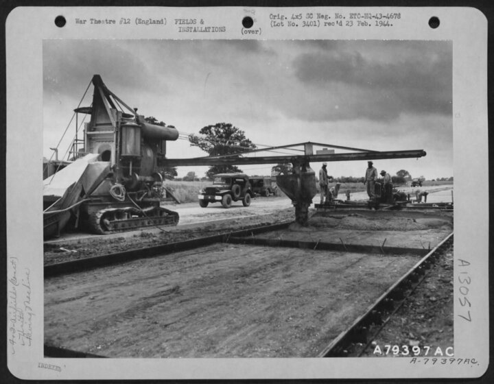 Concrete poured by men of the 923rd for the paving machine to finish at Eye, June 1943 (USAF)