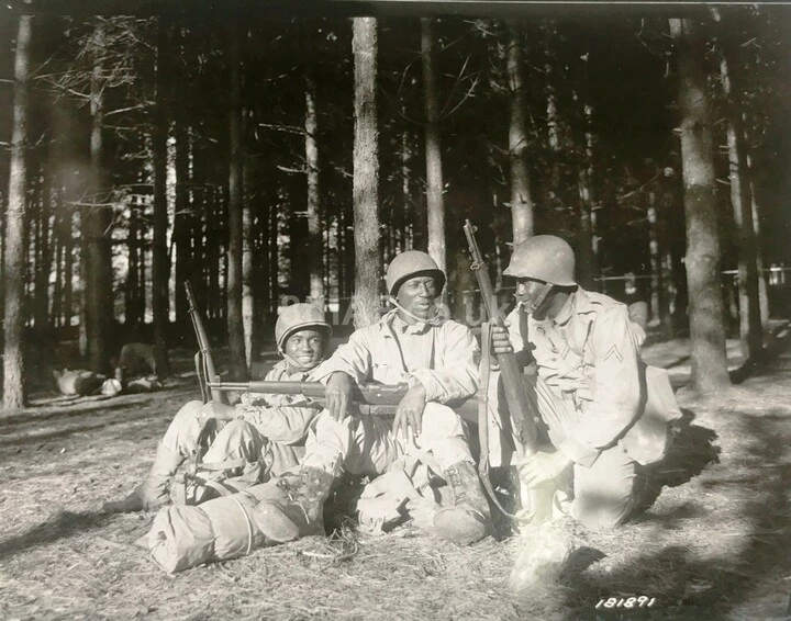 Pfc Houston Calomic, Tec 5 Albert Jackson and Pfc John L. Winkfield from the 923rd at Eye take a brief rest at the Rendlesham Training Ground.