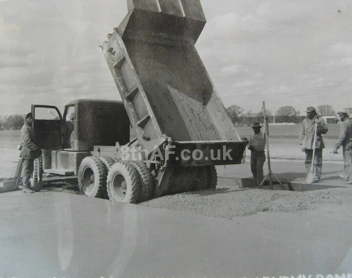 Good as new, Company A of the 827th Engineer Aviation Battalion keep Thorpe Abbotts operational by laying a new concrete repair after enemy bomb damage.